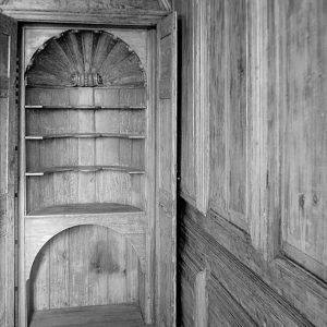 Hidden cupboard with carved shell motif